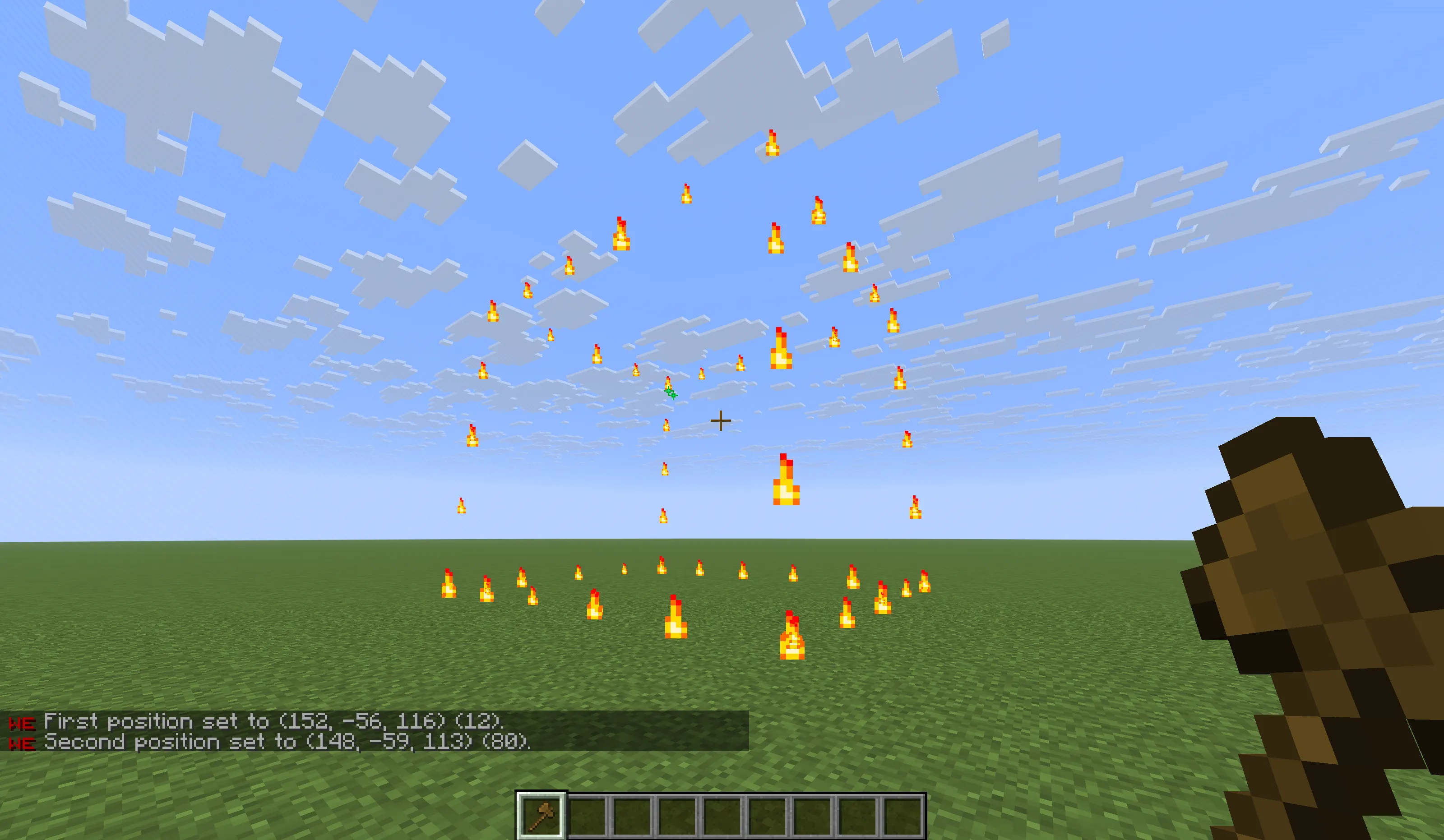 Box outline highlighted with flame particles with chat messages confirming position 1 and position 2 selections.